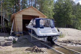 Boat being lifted to the shed along alumunium trails